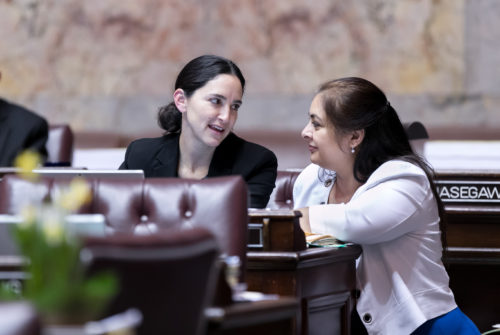 State Sen. Rebecca Saldaña, left, and Sen. Manka Dhingra confer on the floor of the Washington state Senate on March 2, 2018.