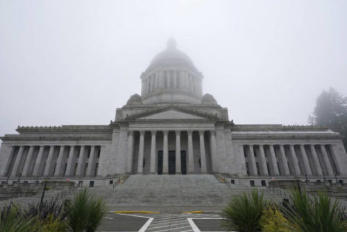 In this Jan. 7, 2021, file photo, the Legislative Building is shown partially shrouded in fog at the Capitol in Olympia, Wash. (AP Photo/Ted S. Warren, File)