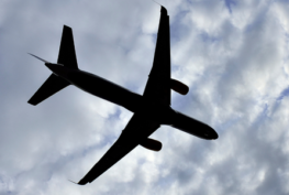 Photograph of an airplane flying in the sky.