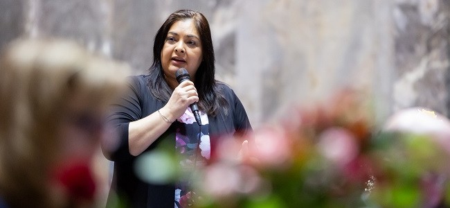 Senator Manka Dhingra holds a microphone and speaks on the senate floor